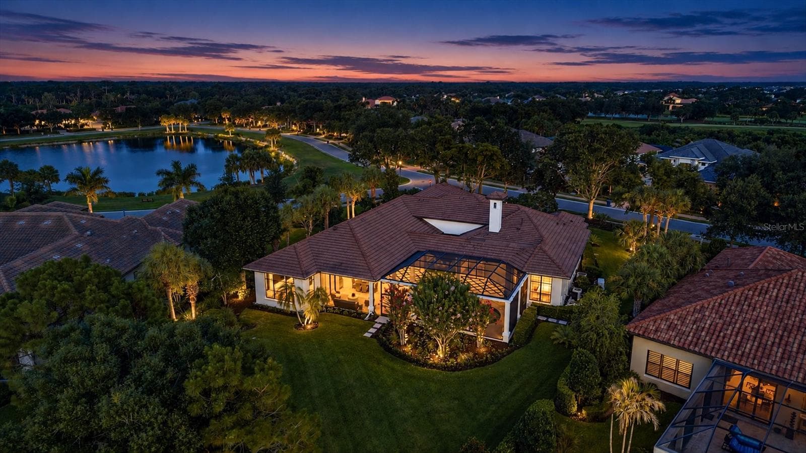 Aerial Photo of the Back Yard, Pool and Lanai's at Twilight - 9261 MCDANIEL LN, SARASOTA