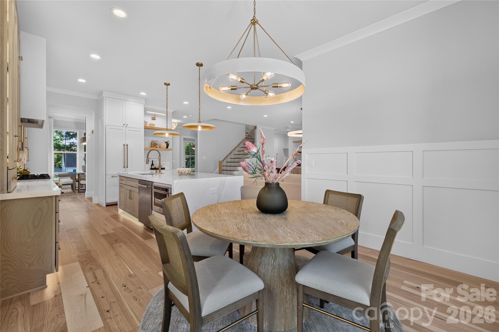 Breakfast area with wainscoting, crown molding, bespoken lighting - Charlotte