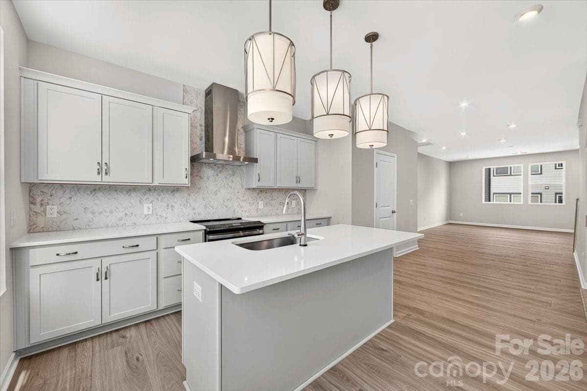 Frost white cabinets paired with white quartz countertops - Charlotte