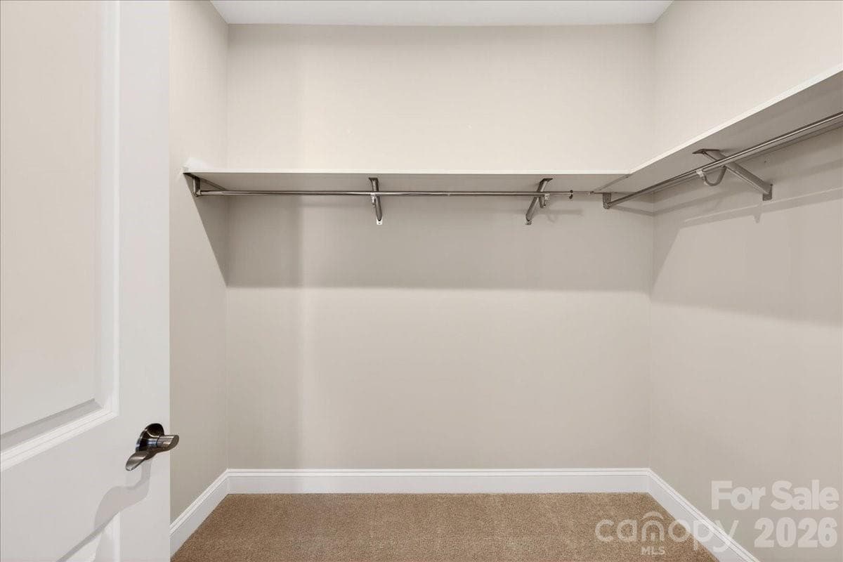 Primary walk-in closet with upgraded shelving - 12015 Elsa Lane, Charlotte