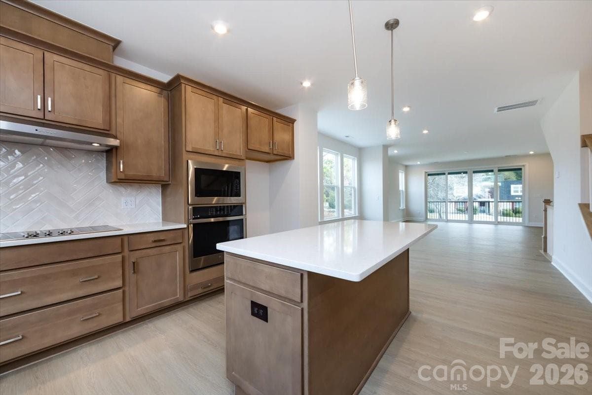 Warm brown cabinets with white quartz countertops - Charlotte