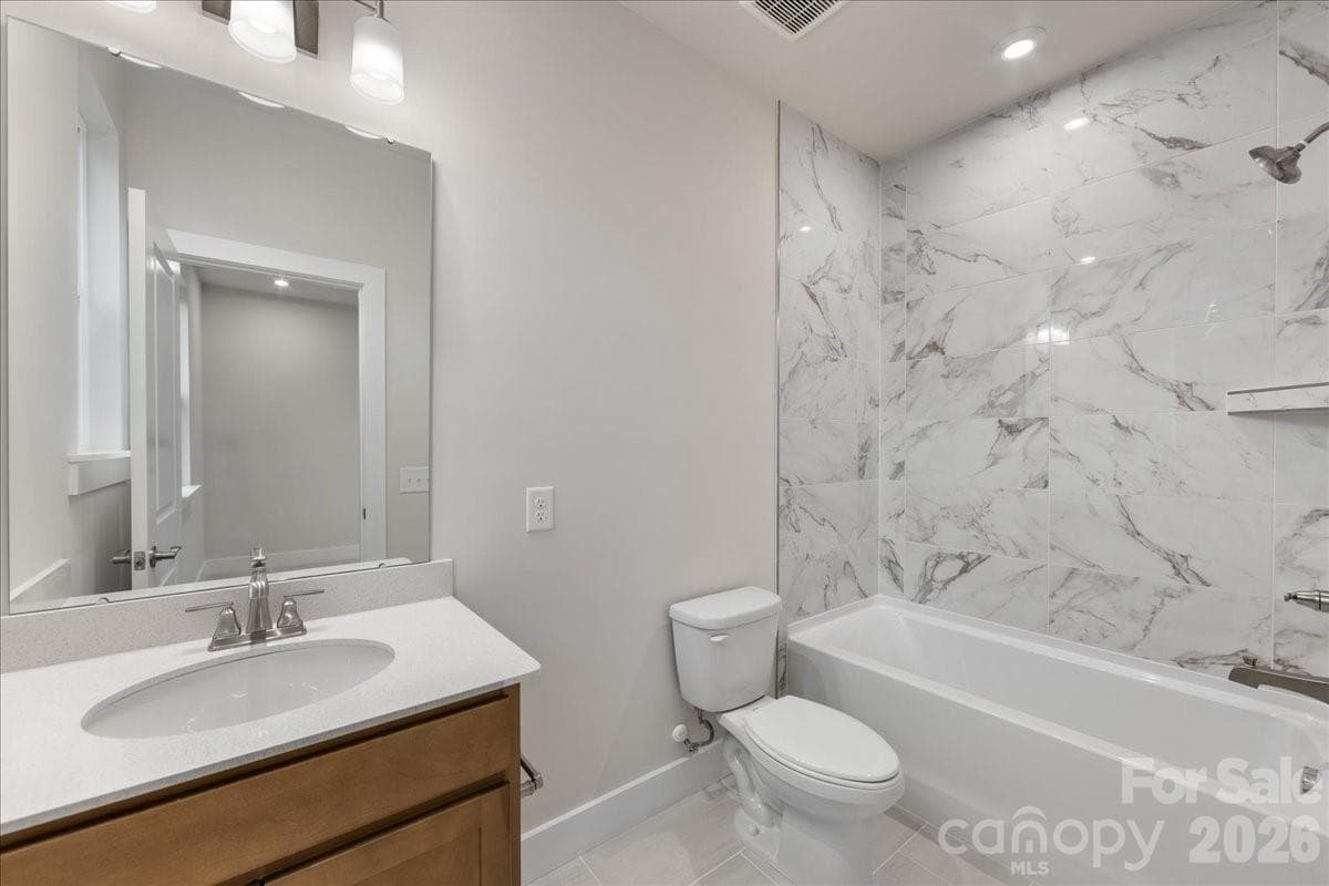 Secondary bathroom with tiled walls above the tub - Charlotte