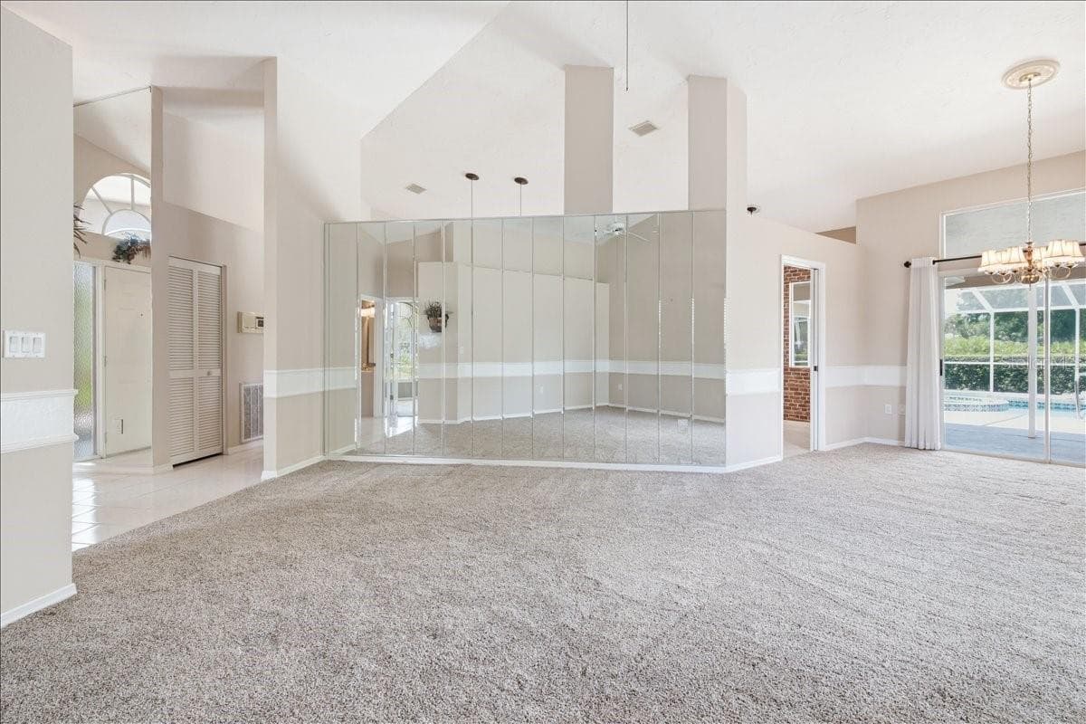 Open main living and dining rooms with openings into kitchen and den - 7015 PLEASANT HILL RD, BRADENTON