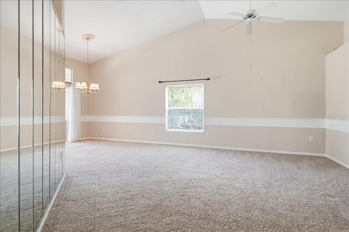 View from entry through living room, and into dining room - 7015 PLEASANT HILL RD, BRADENTON