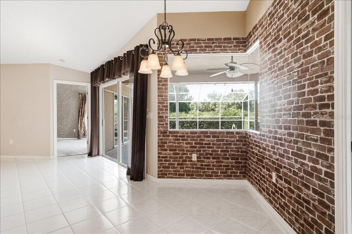 Breakfast nook with brick wallpaper create European bistro atmosphere - 7015 PLEASANT HILL RD, BRADENTON