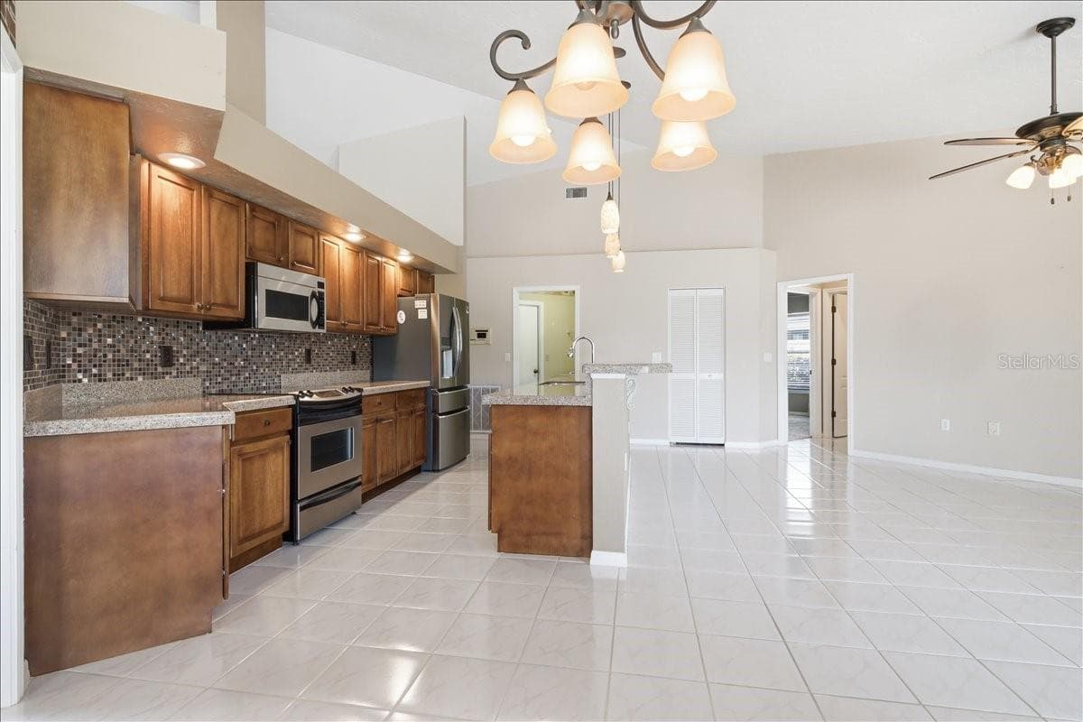 Kitchen is a center of home and connects all living spaces - 7015 PLEASANT HILL RD, BRADENTON