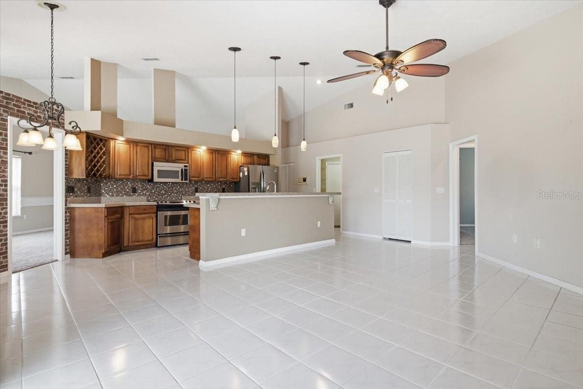View from Den slider into open Den and kitchen - 7015 PLEASANT HILL RD, BRADENTON