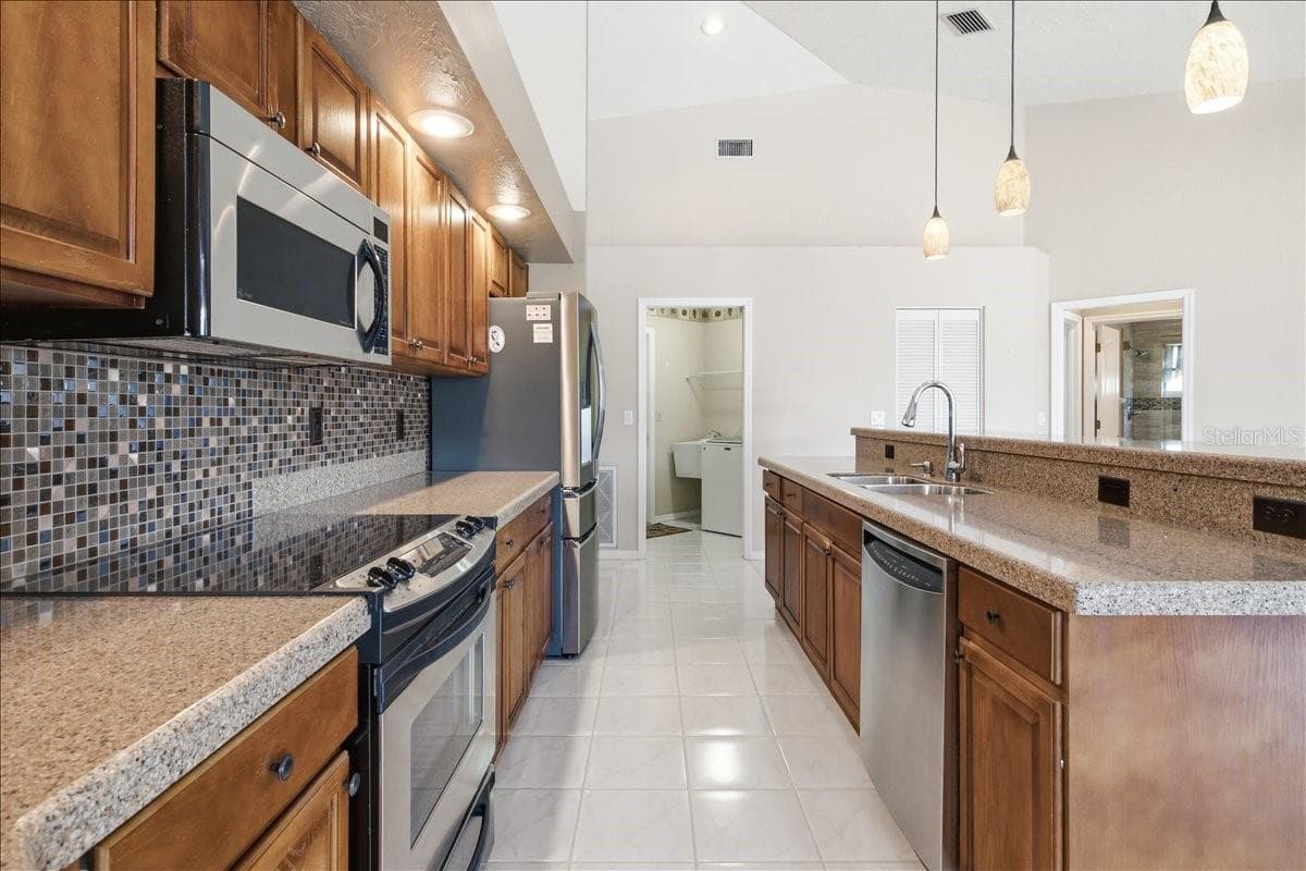Laundry room and garage access at back of kitchen - 7015 PLEASANT HILL RD, BRADENTON