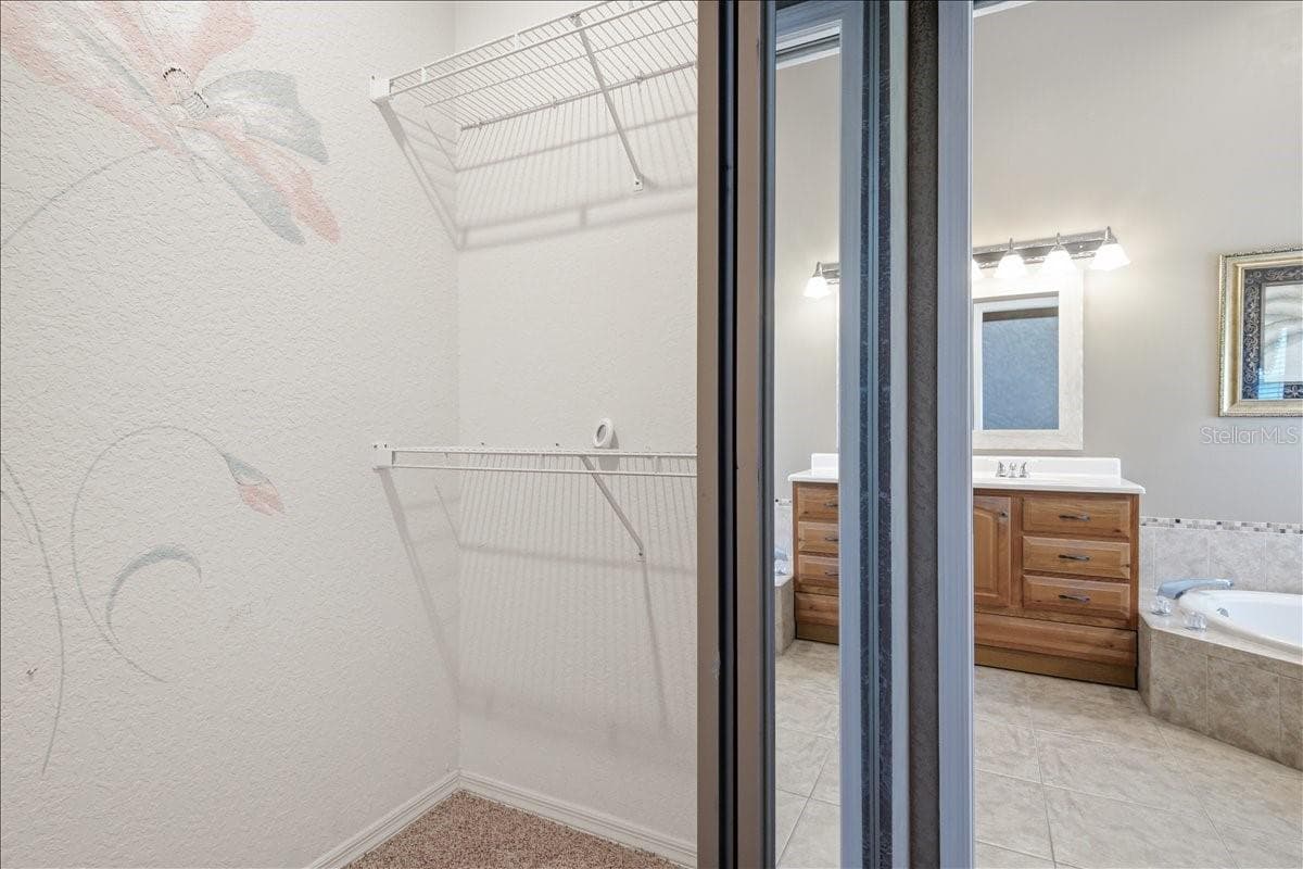 Two large walk-in closets in hall into ensuite bath - 7015 PLEASANT HILL RD, BRADENTON