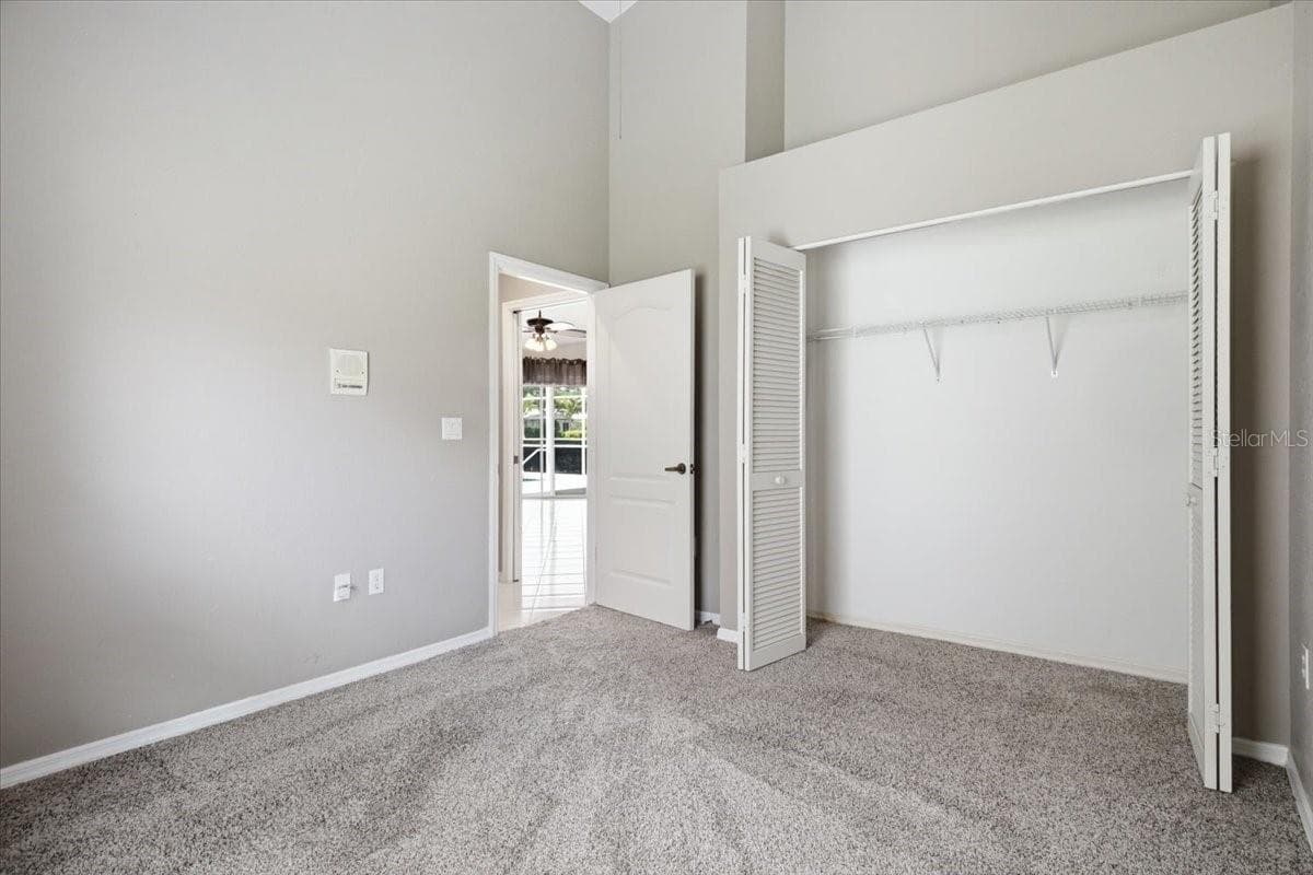 View from Bedroom two to closet and hallway - 7015 PLEASANT HILL RD, BRADENTON