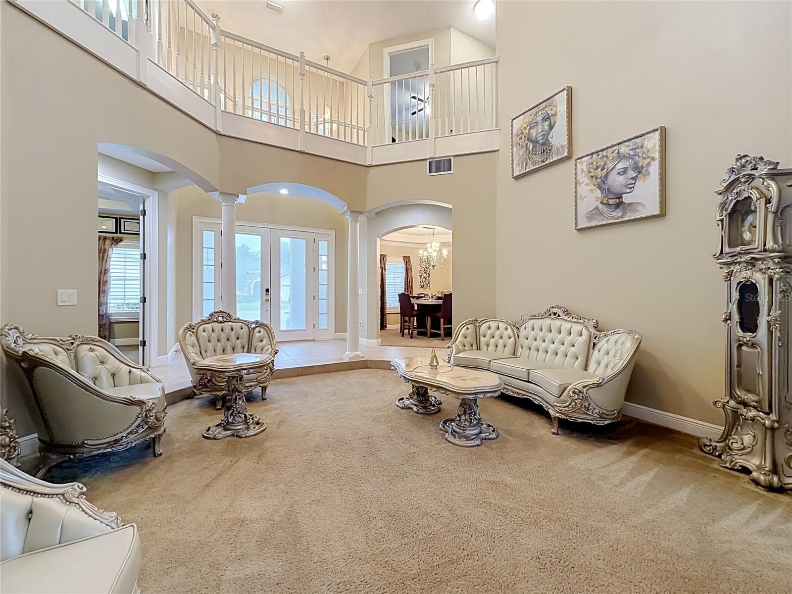 Double door entry foyer, formal living area, soaring ceilings, architectural features. - 3405 HEIRLOOM ROSE PL, OVIEDO