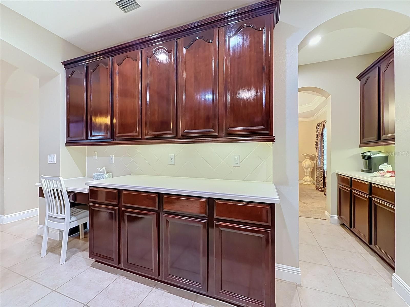 Built in desk area and view of Butler's pantry. - 3405 HEIRLOOM ROSE PL, OVIEDO