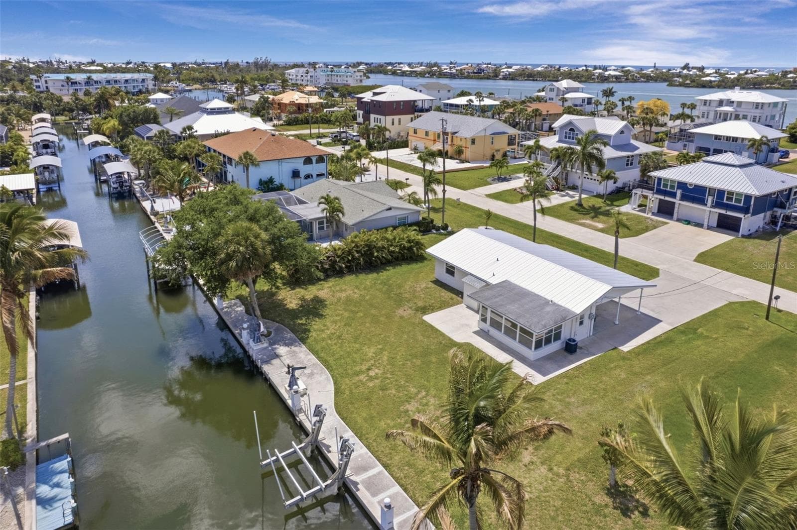 Back of home and saltwater canal with boat lift. . Facing Southwest. - 10451 MARION ST, ENGLEWOOD