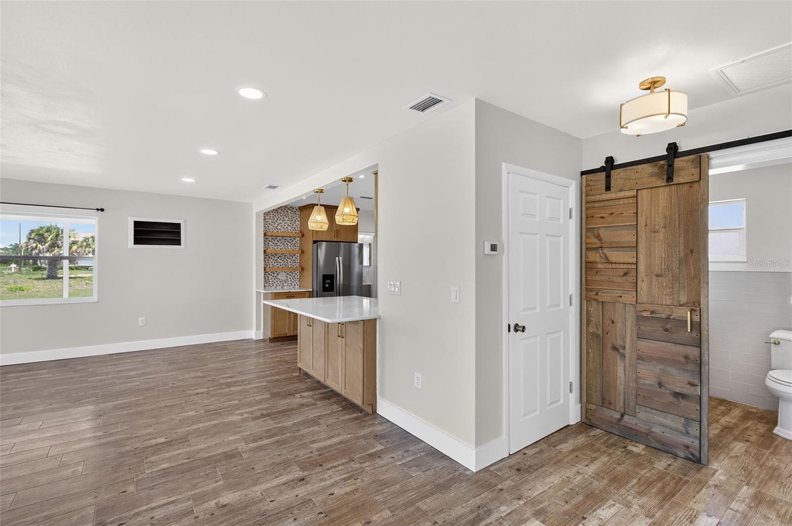 View from second bedroom door towards primary bathroom, closet, living area and kitchen - 10451 MARION ST, ENGLEWOOD