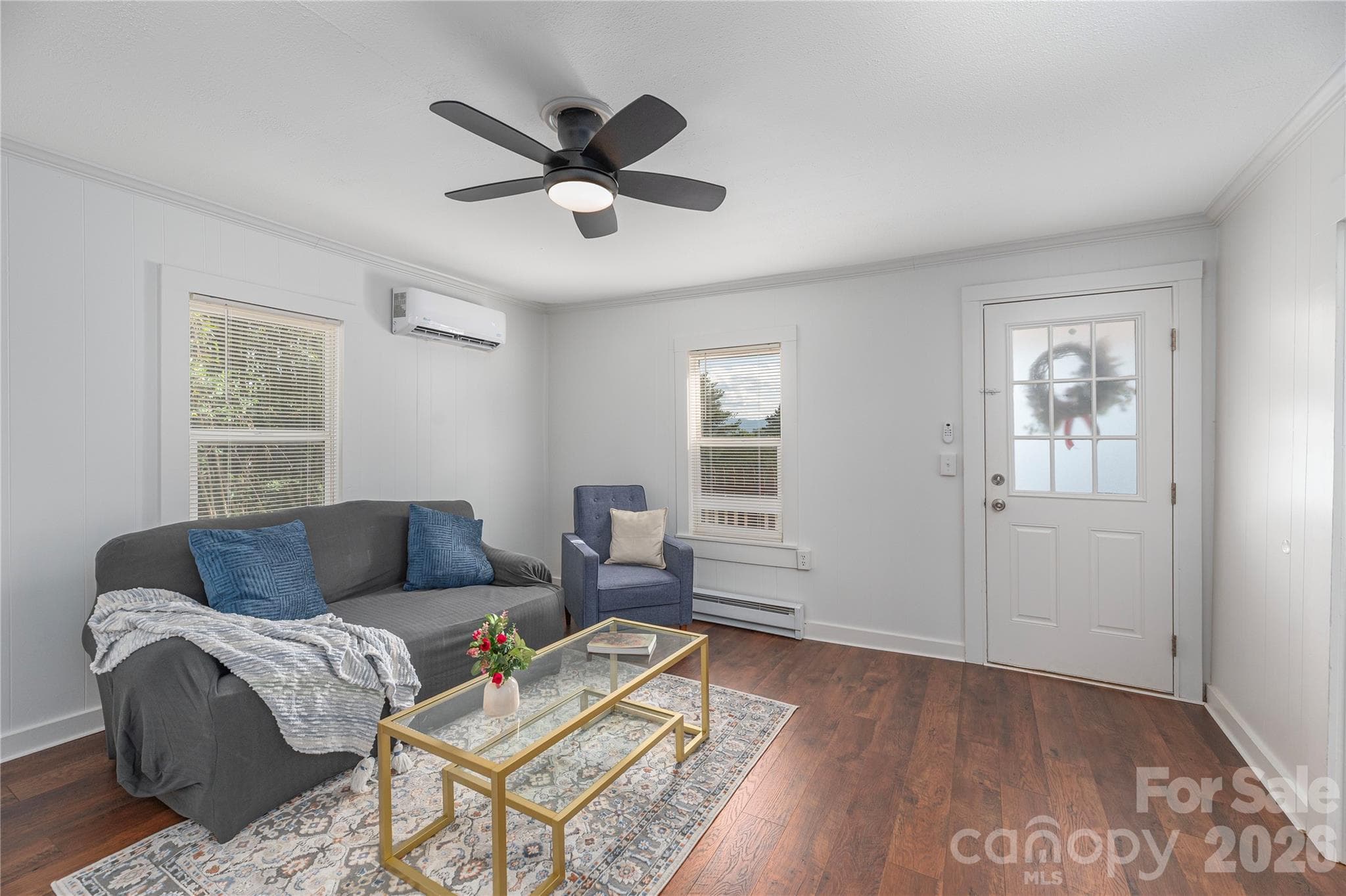 Light-filled living room with updated flooring and comfortable gathering space. - Canton