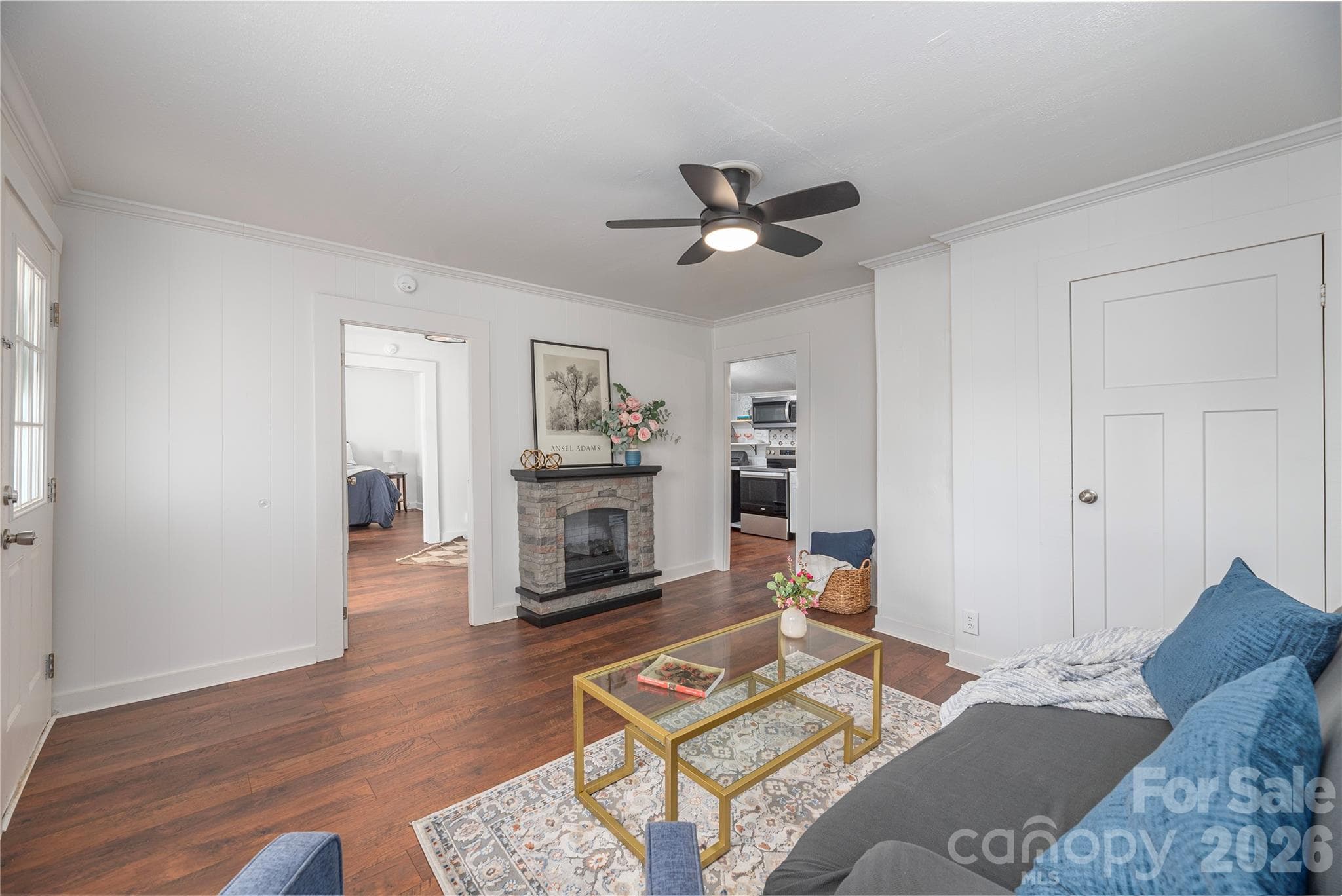 Inviting living room featuring an electric fireplace and updated finishes. - Canton