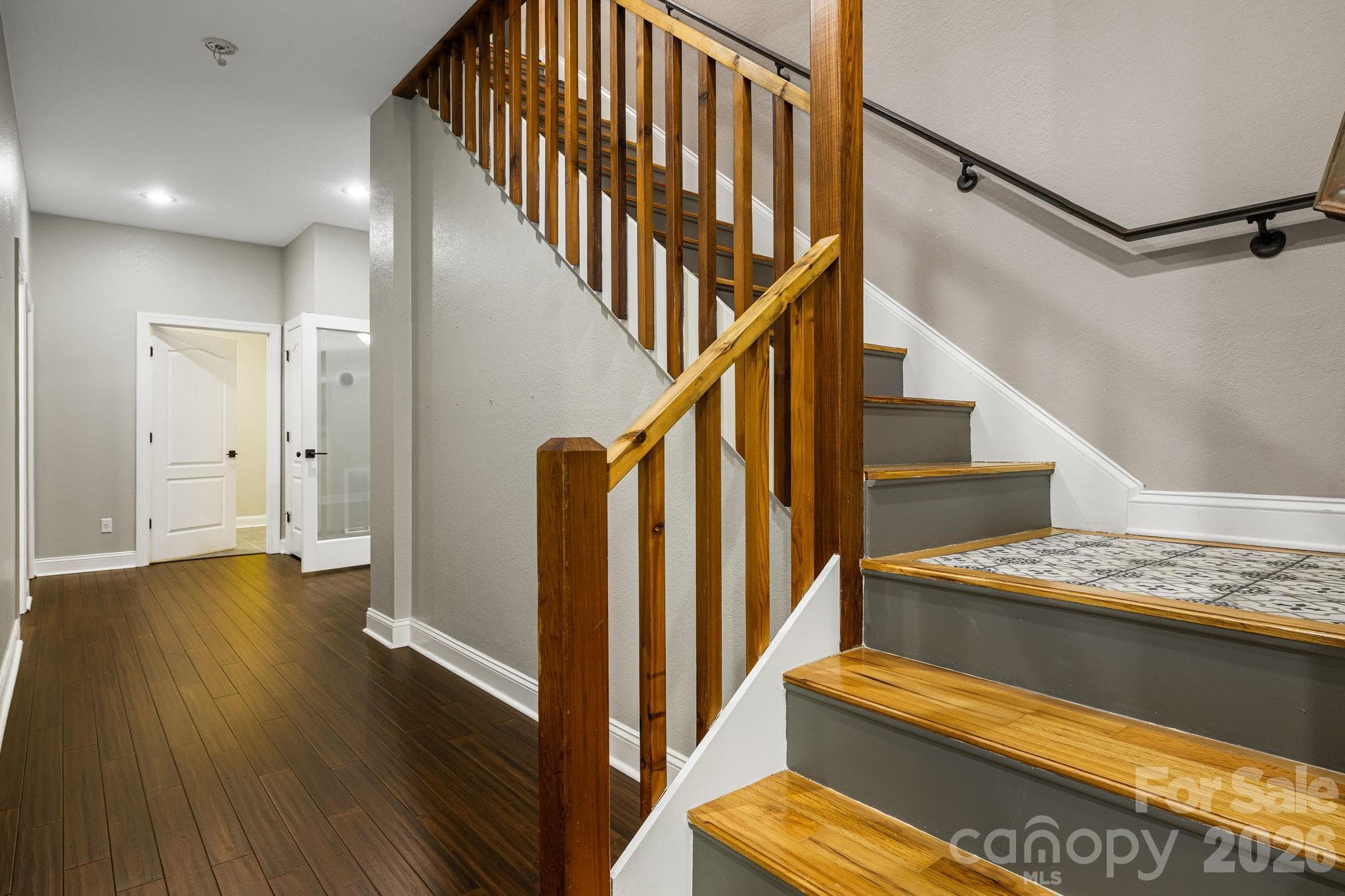 Downstairs stair landing with custom tile - Hendersonville