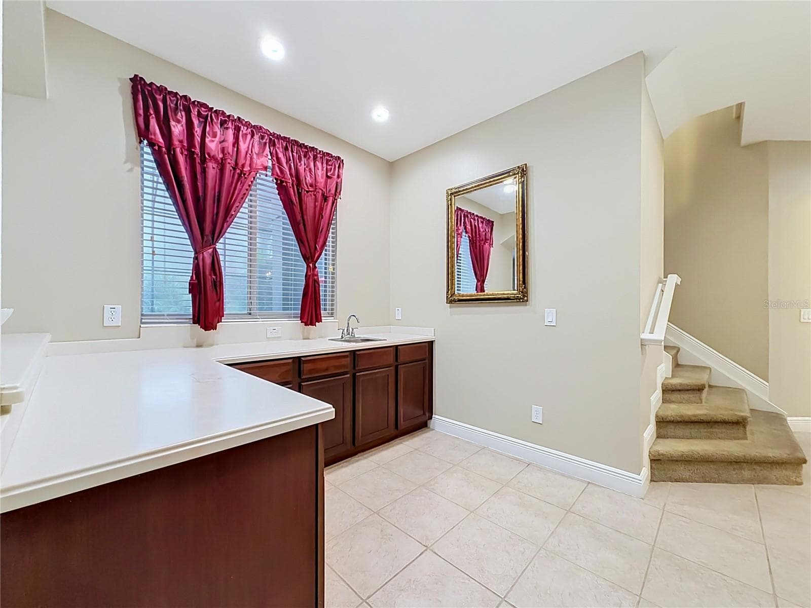 Wet bar/prep area. Corian counters, cabinets and sink. View of screened patio. - 3405 HEIRLOOM ROSE PL, OVIEDO