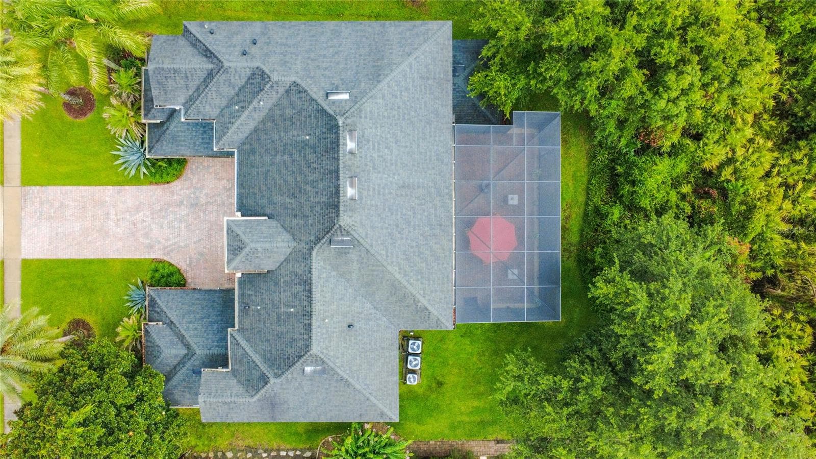 Overhead view of the wooded backdrop and 2-story screen enclosure. - 3405 HEIRLOOM ROSE PL, OVIEDO