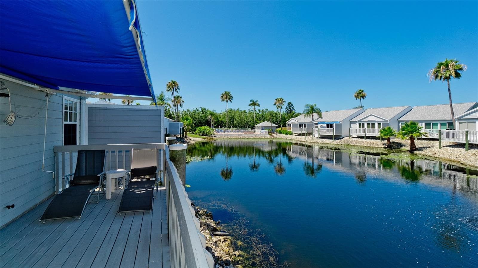 DECK OVERLOOKING WATER LILY FILLED LAKE - 506 WOODSTORK CIR, BRADENTON