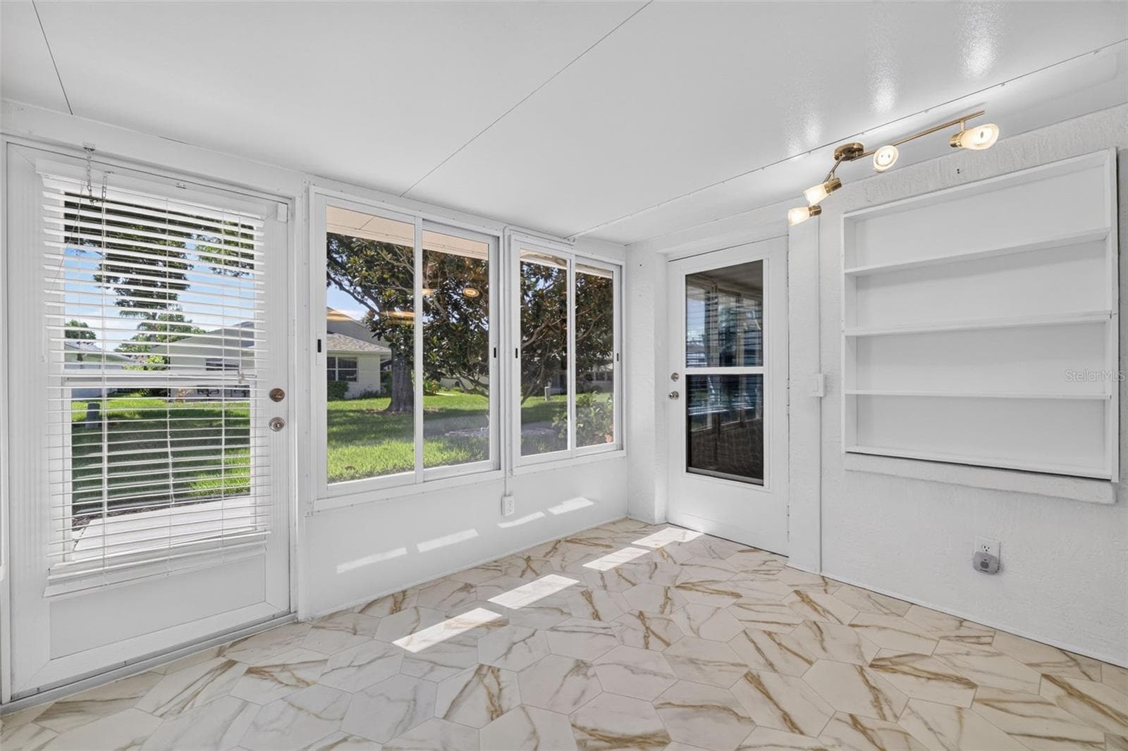 Florida Room with Built-In Bookshelf - 4431 FERN DR, BRADENTON