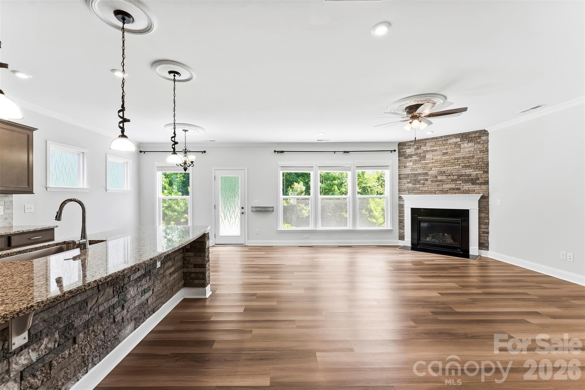 This Spacious Great Room is freshly painted.  Gorgeous Flooring, Upgraded Lighting.  Gas Fireplace.  Wall of Windows for lots of natural lighting.  Open Concept Floor Plan - 1318 Poppy Way, Matthews