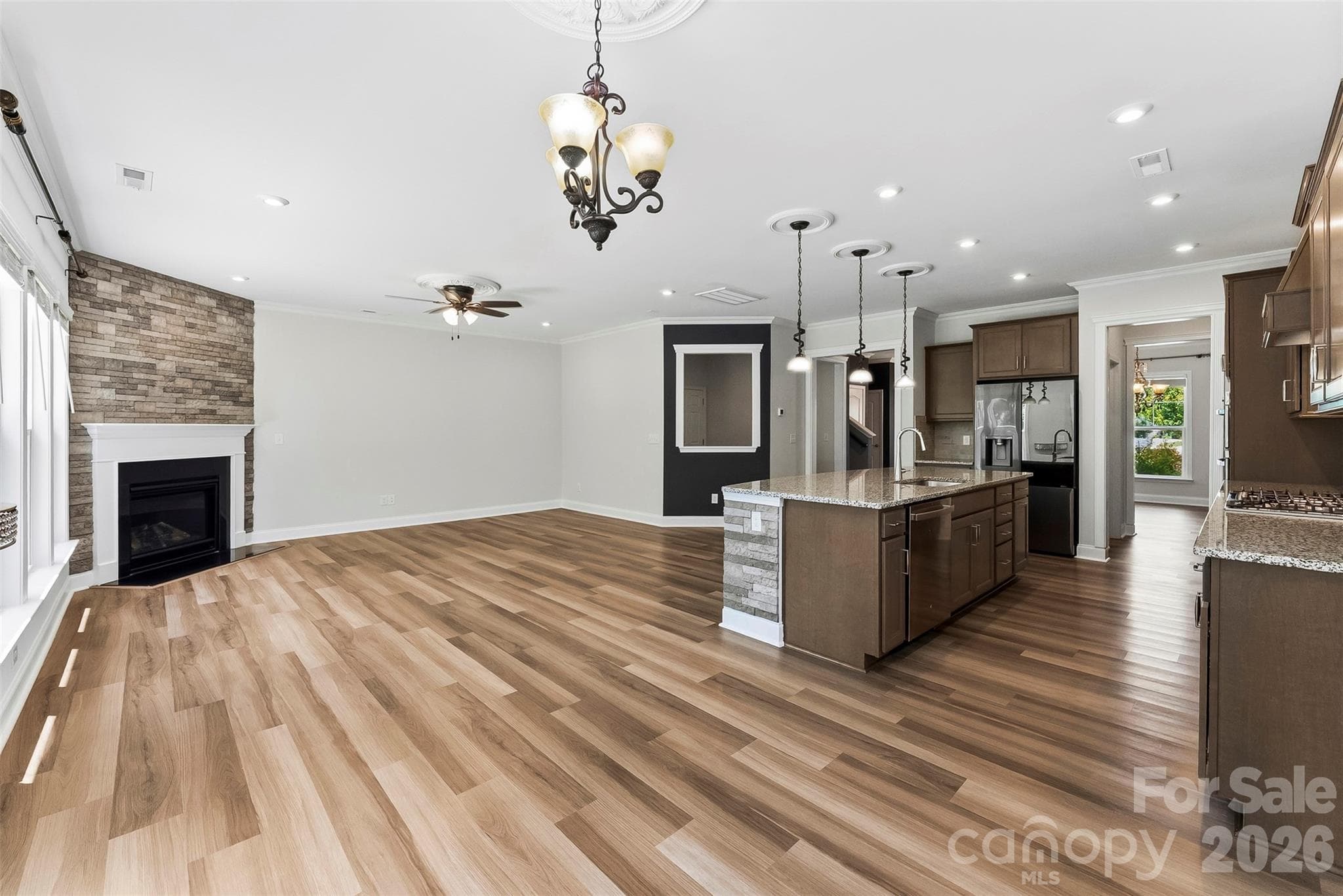 View from the Breakfast Room into the Kitchen and Great Room.  Gorgeous Flooring, Freshly painted, upgraded lighting. - 1318 Poppy Way, Matthews