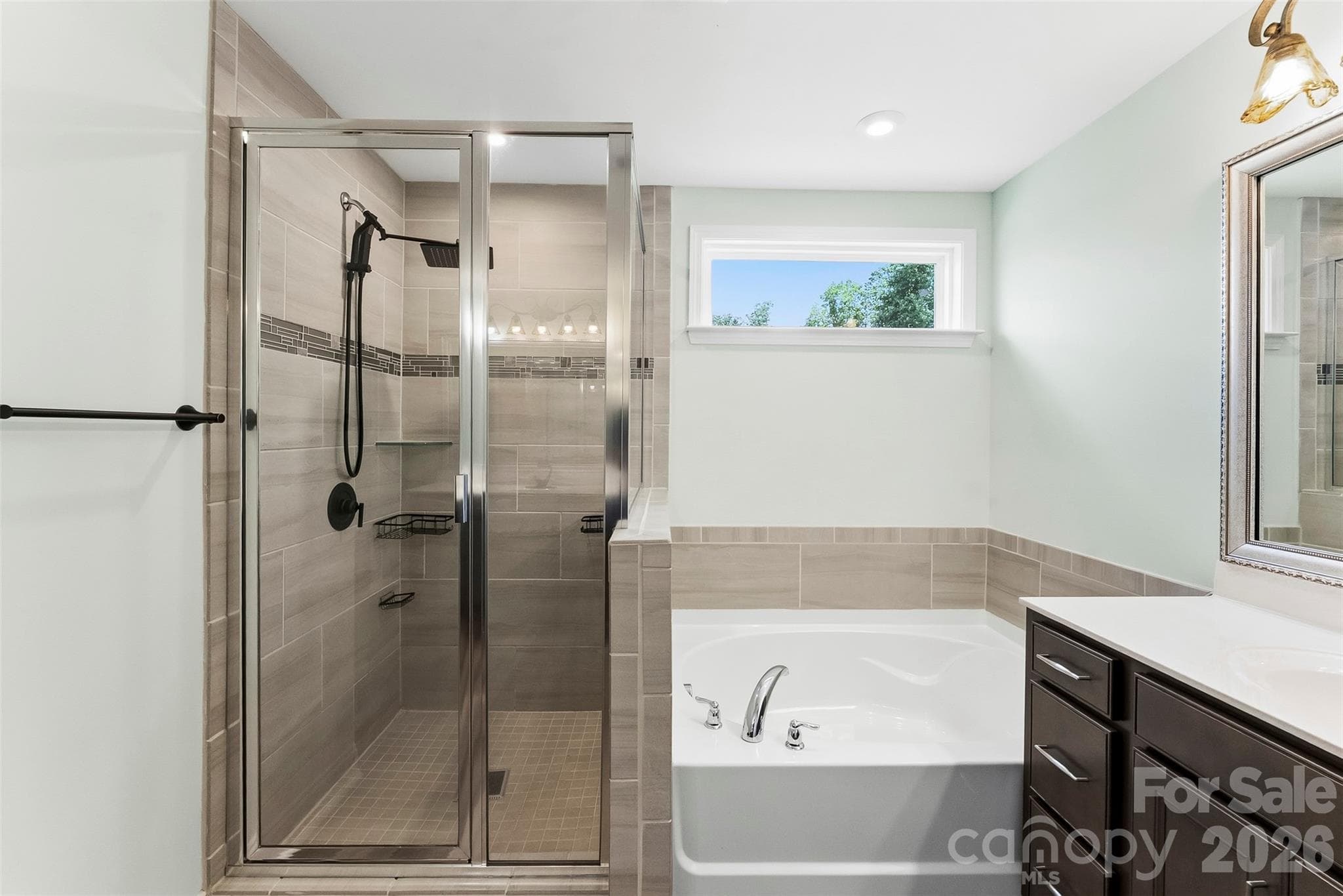 Beautiful tile work in the shower.  Rain shower head - 1318 Poppy Way, Matthews