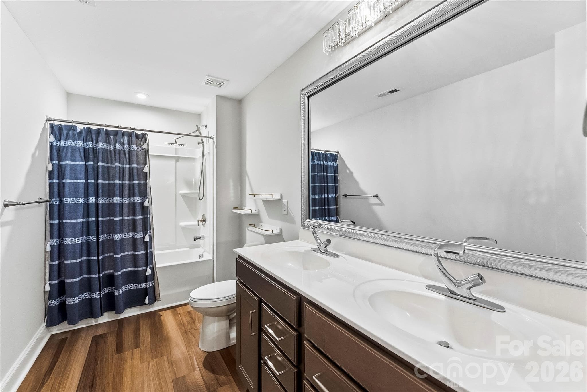 Spacoius Secondary Full Bathroom has dual vanities, upgraded cabinetry and faucets/lighting.  Rain Shower head - 1318 Poppy Way, Matthews