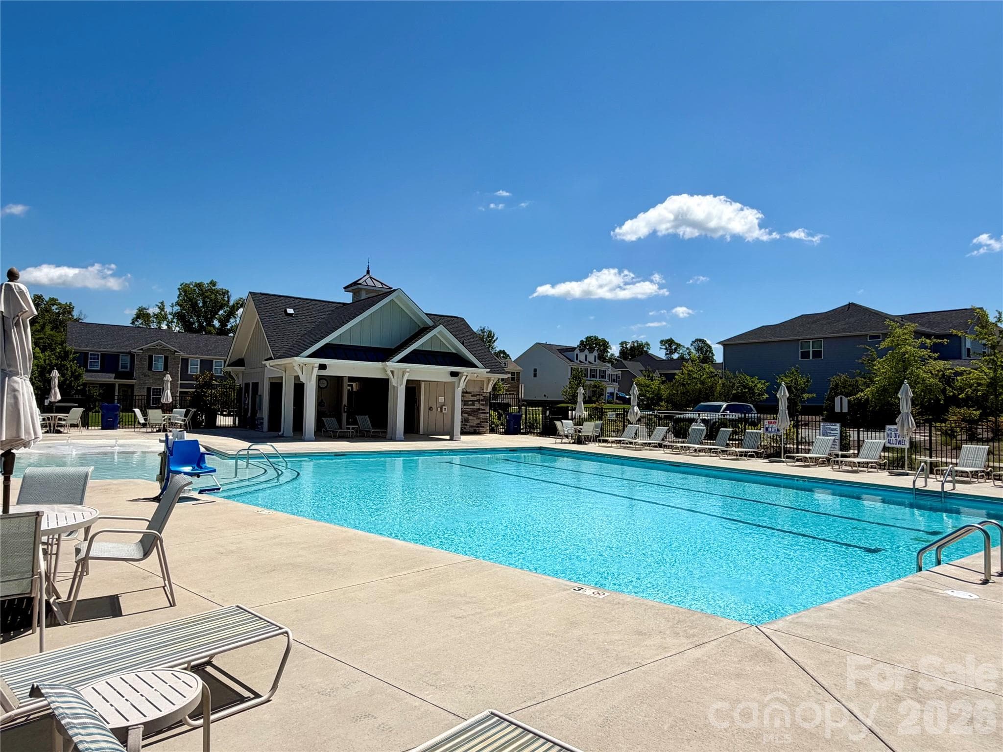 Spacious Community Pool with lots of chairs and umbrellas.  Cabanna - 1318 Poppy Way, Matthews