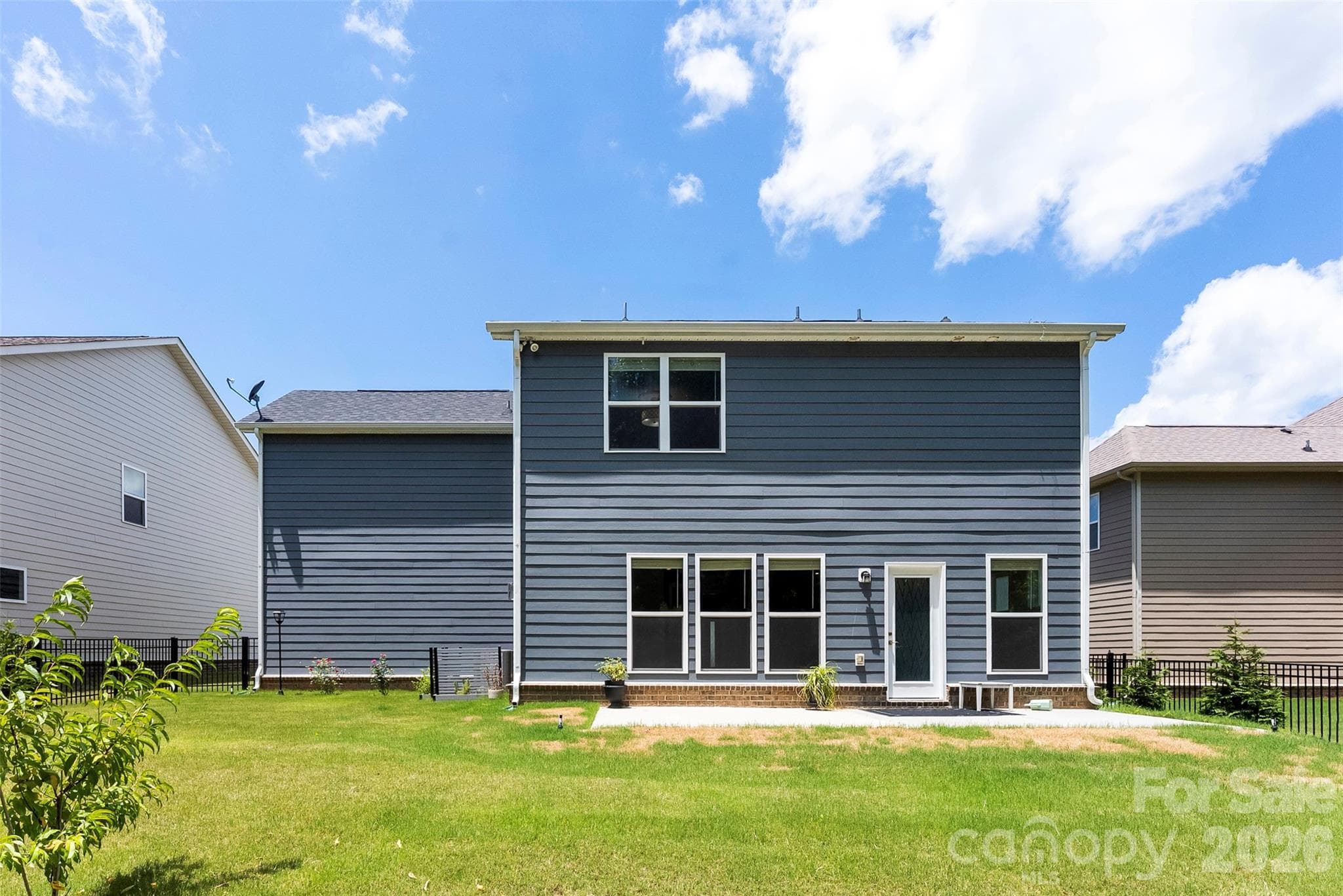 Real of home features patio.  Flat backyard. - 1318 Poppy Way, Matthews