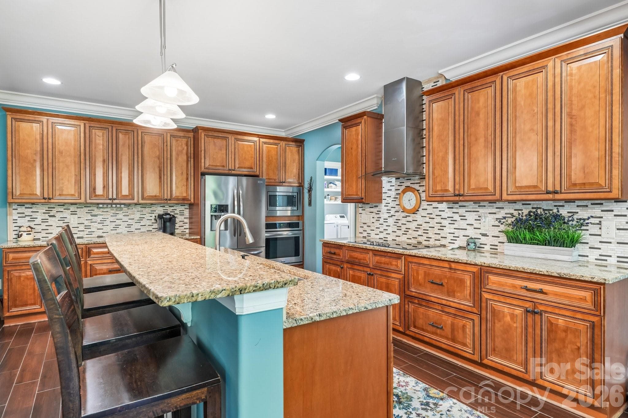 The gourmet kitchen showcases custom cabinetry, - Charlotte