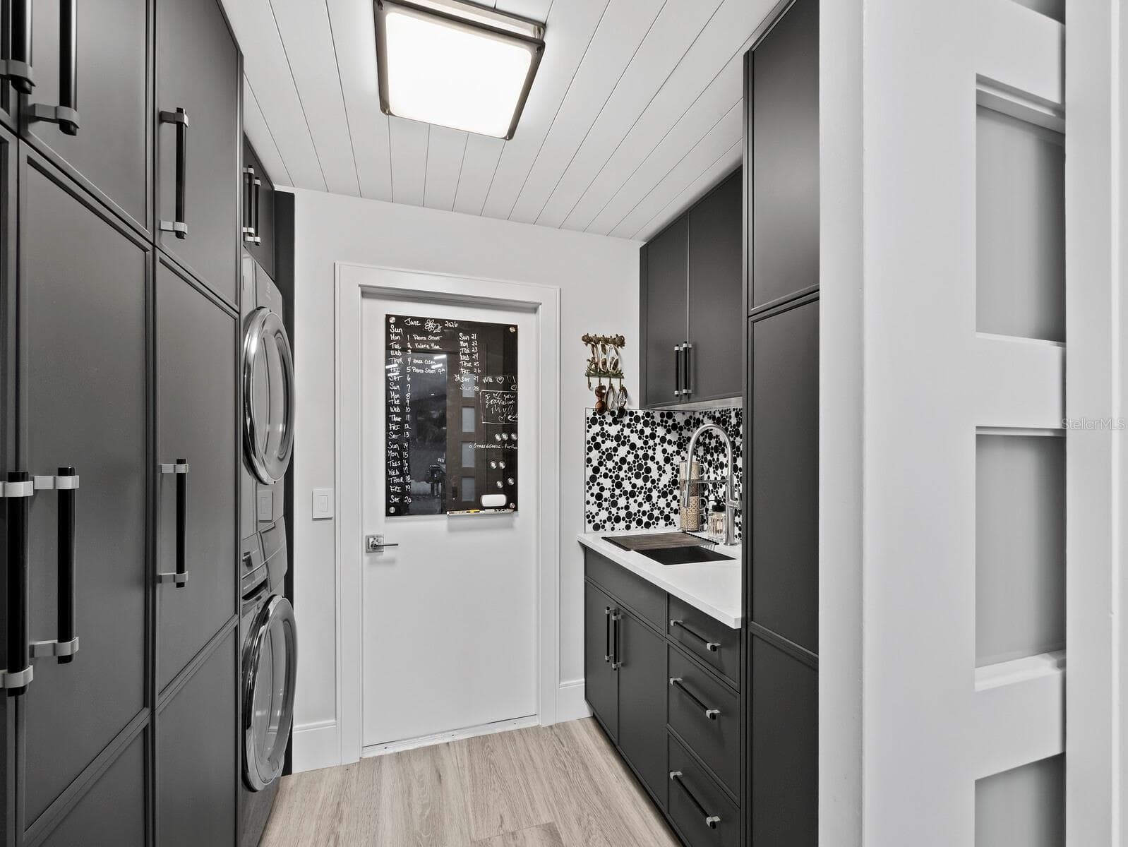 laundry, coffee bar with sink and floor to ceiling cabinets - 206 FOUR KNOT LN, OSPREY