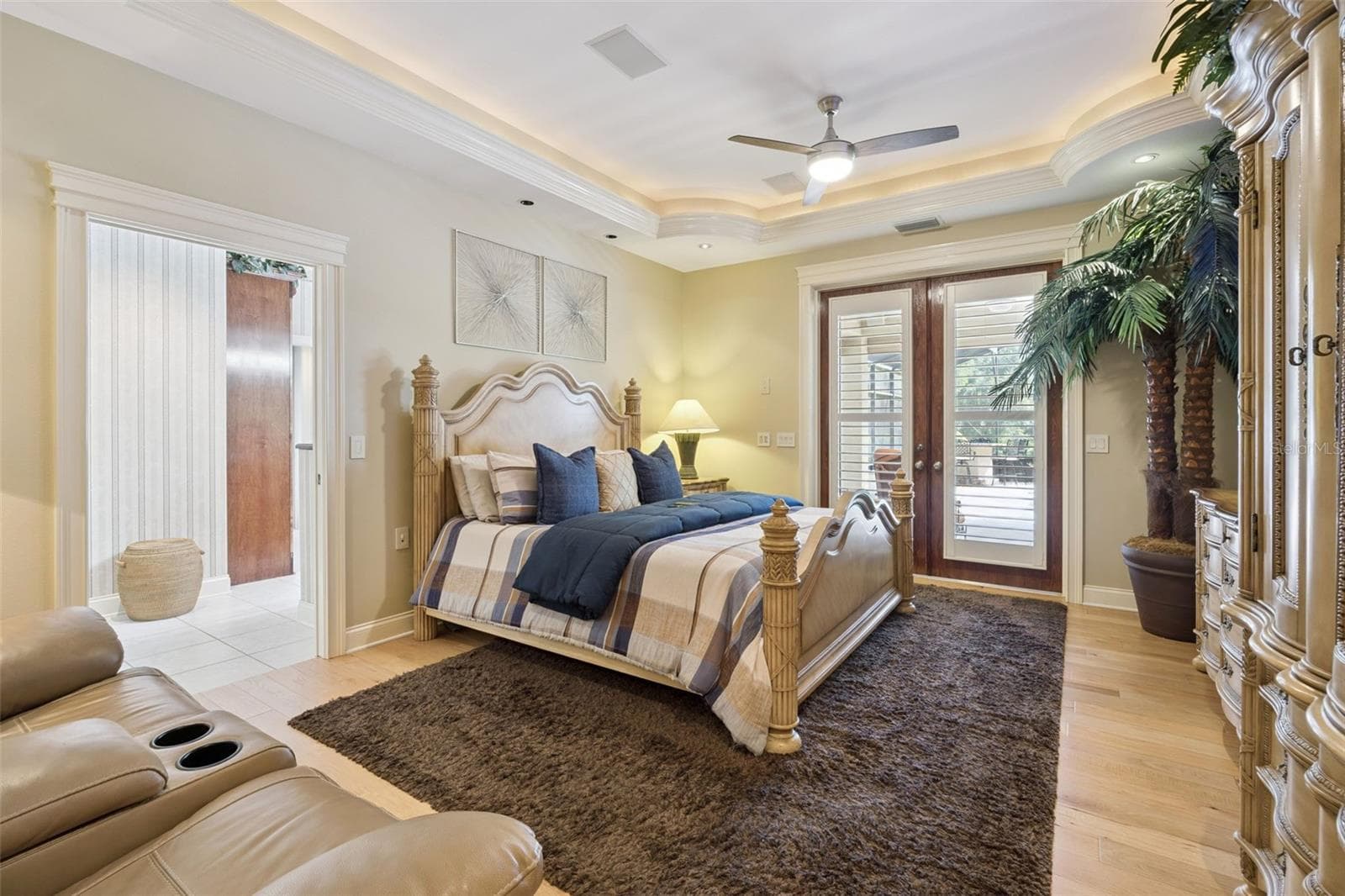 Primary Suite with tray ceiling and access to the pool - 605 OLD MOUNT DORA RD, EUSTIS