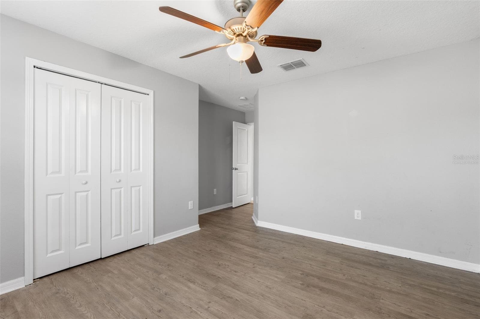 Virtually staged to show how comfortably the room accommodates a bed, nightstands, seating, and additional furniture. - 6810 TRENT CREEK DR, SUN CITY CENTER