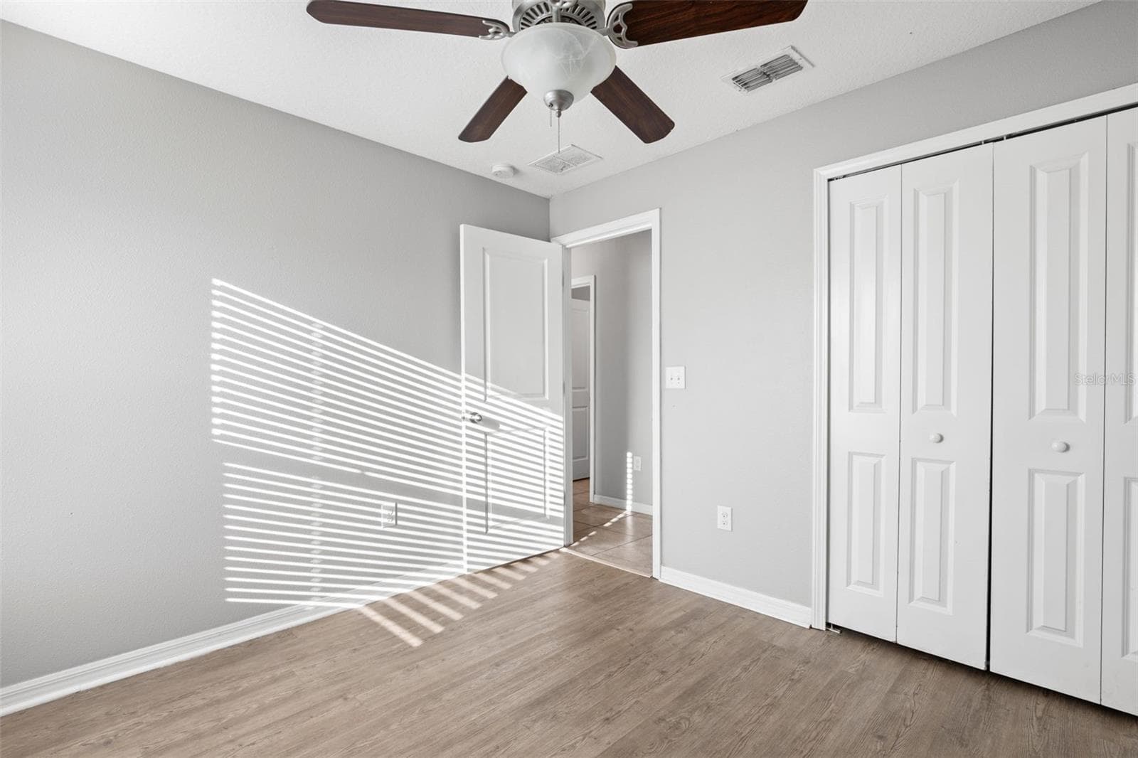 Primary bedroom highlights its generous proportions, natural light, and ample wall space for flexible furniture placement. - 6810 TRENT CREEK DR, SUN CITY CENTER