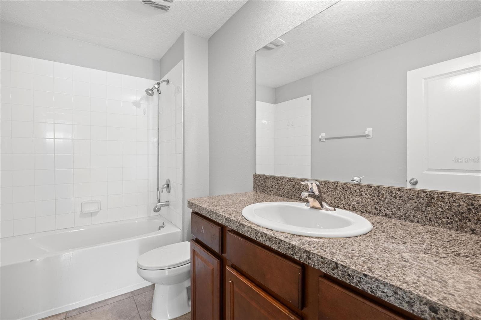 Dedicated laundry room with upper wire shelving for convenient storage and organization. - 6810 TRENT CREEK DR, SUN CITY CENTER