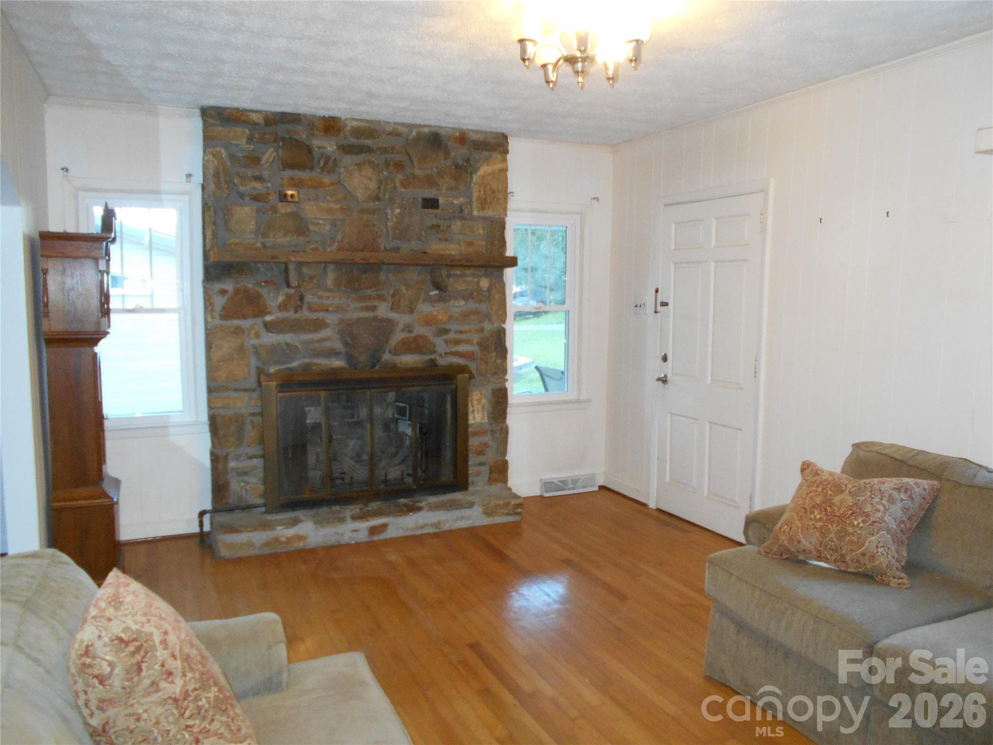 Stone gas fireplace in living room with original hardwood floors - Black Mountain