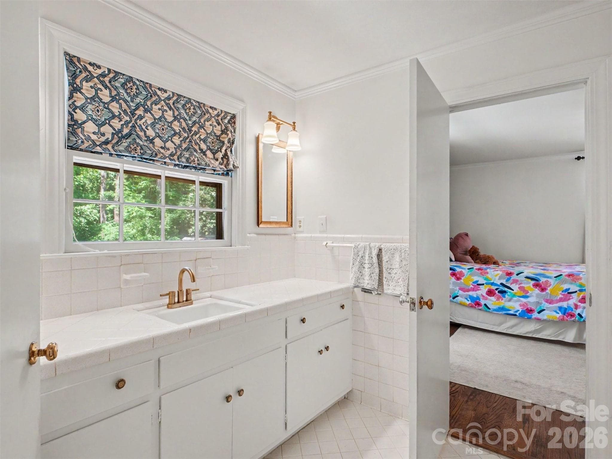A well-appointed bath, shared with the bedroom next door but that could be closed off to provide an en suite for just the primary - 441 Claymont Street SE, Concord