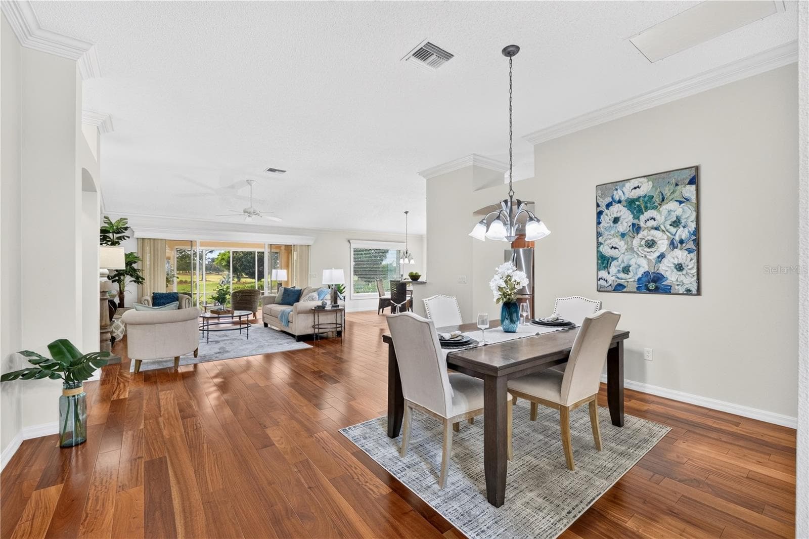Open dining area with beautiful wood flooring, high ceilings, and an easy flow into the living room and kitchen. - 16815 SE 85TH BELKNAP AVE, THE VILLAGES