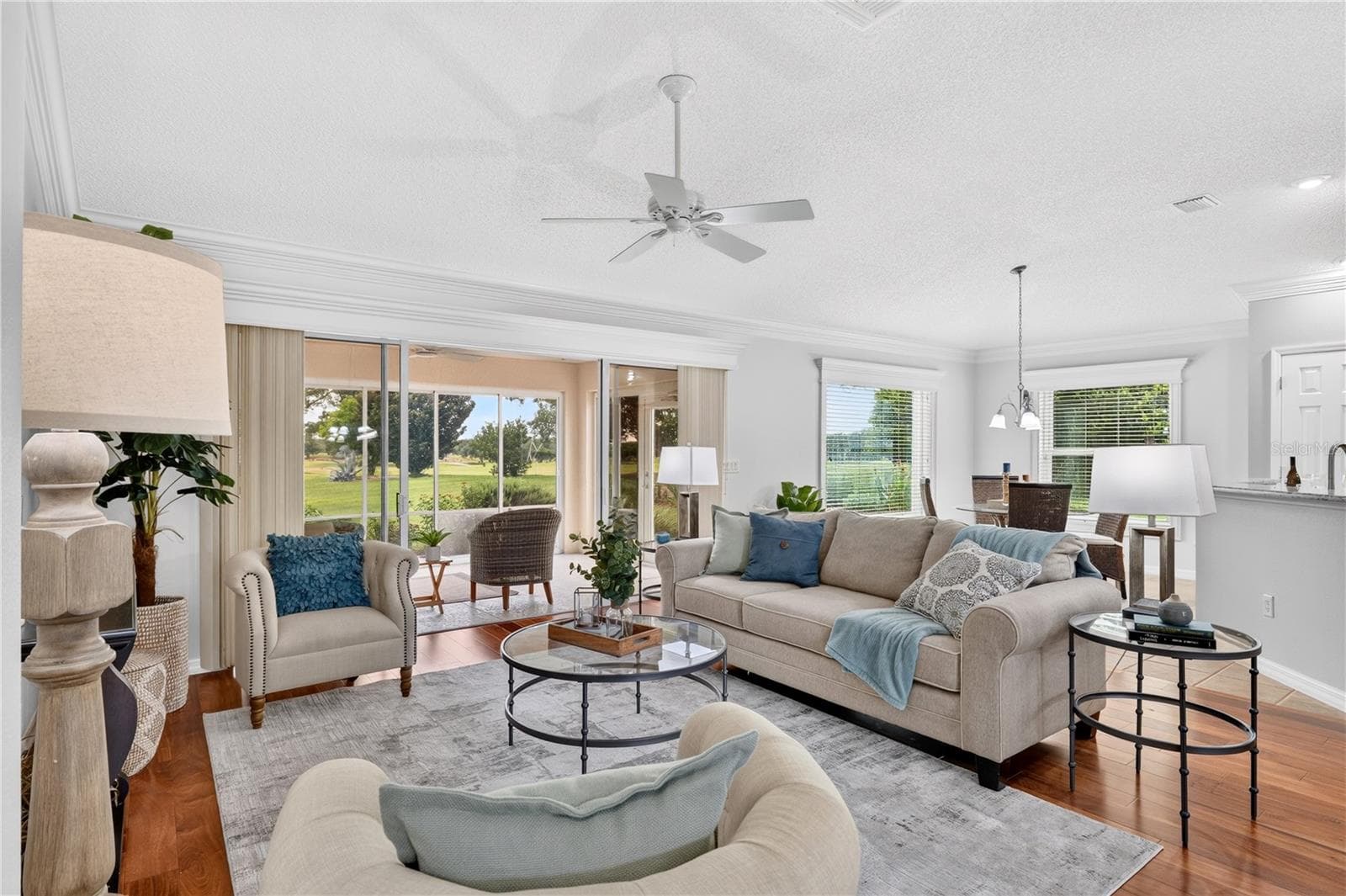 Inviting living room with an open layout, abundant natural light, and seamless connection to the dining and kitchen areas. - 16815 SE 85TH BELKNAP AVE, THE VILLAGES