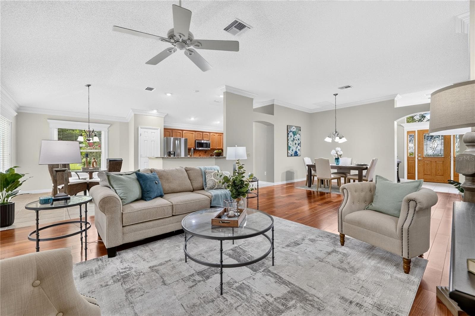 Open living room with high ceilings, neutral finishes, and a comfortable layout that flows easily into the dining and kitchen areas - 16815 SE 85TH BELKNAP AVE, THE VILLAGES