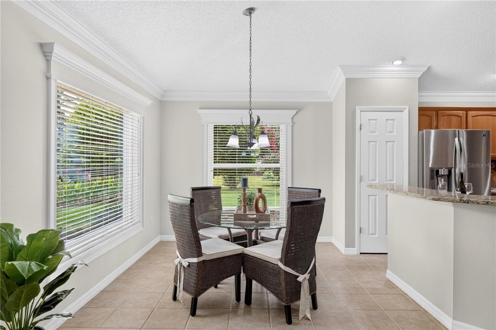 Charming breakfast nook with large windows, soft natural light, and peaceful views of the surrounding green space. - 16815 SE 85TH BELKNAP AVE, THE VILLAGES