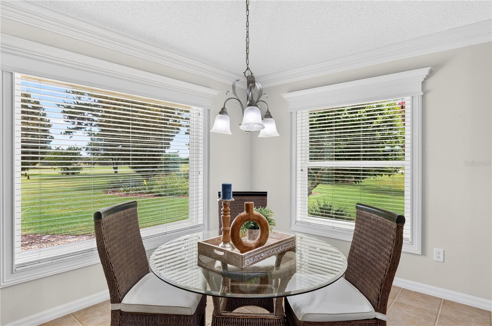 Breakfast nook surrounded by windows, offering a bright and inviting space to enjoy morning coffee with scenic views. - 16815 SE 85TH BELKNAP AVE, THE VILLAGES