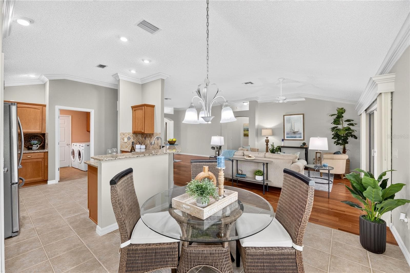 Bright breakfast nook with large windows, pendant lighting, and an open flow to the kitchen and living room. - 16815 SE 85TH BELKNAP AVE, THE VILLAGES