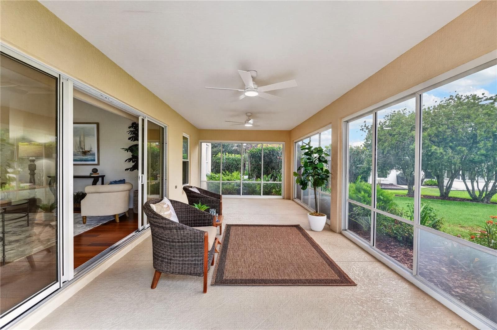 Spacious lanai offering multiple seating areas, natural light, and a peaceful connection to the surrounding outdoor views. - 16815 SE 85TH BELKNAP AVE, THE VILLAGES