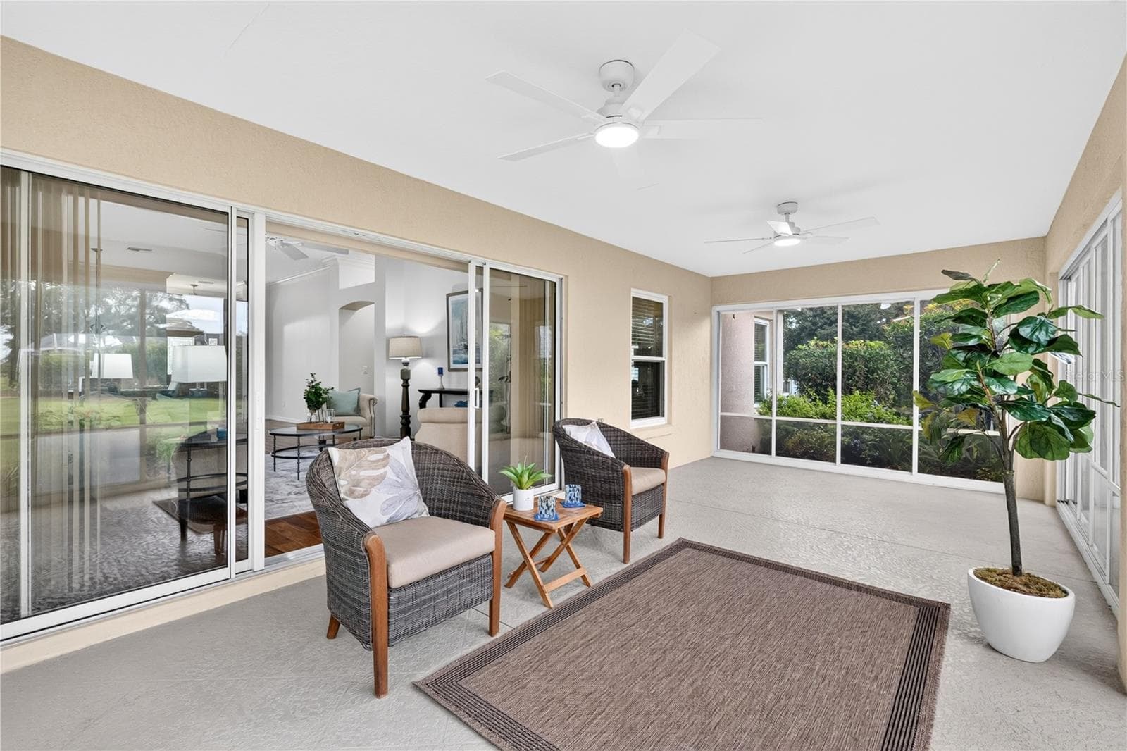 Bright enclosed lanai with sliding glass doors, ceiling fan, and plenty of room for relaxing or entertaining. - 16815 SE 85TH BELKNAP AVE, THE VILLAGES