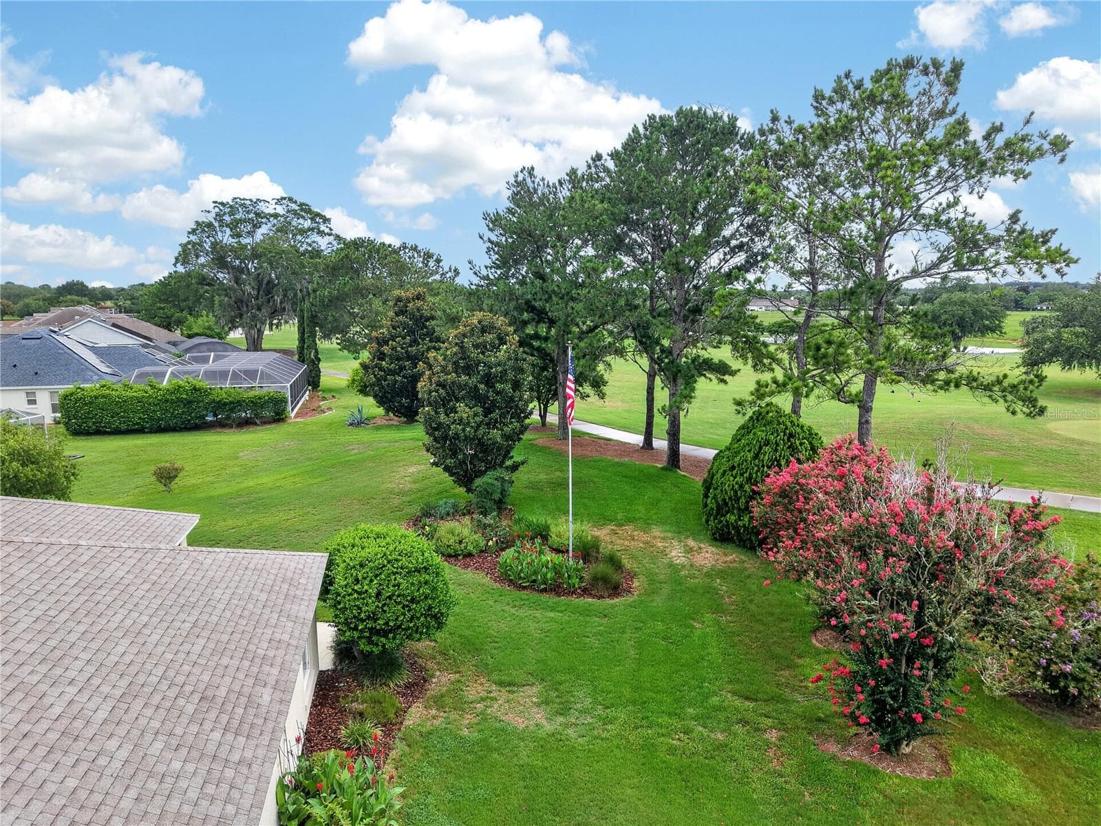 Aerial view highlighting the beautiful rear lawn, mature landscaping, and peaceful golf course backdrop. - 16815 SE 85TH BELKNAP AVE, THE VILLAGES