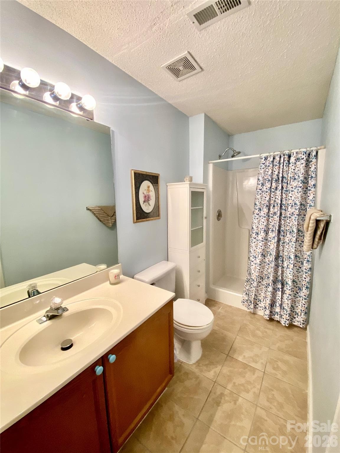 Primary Full Bath, walk-in shower, cabinet with lots of shelving. - 6025 Creft Circle, Indian Trail