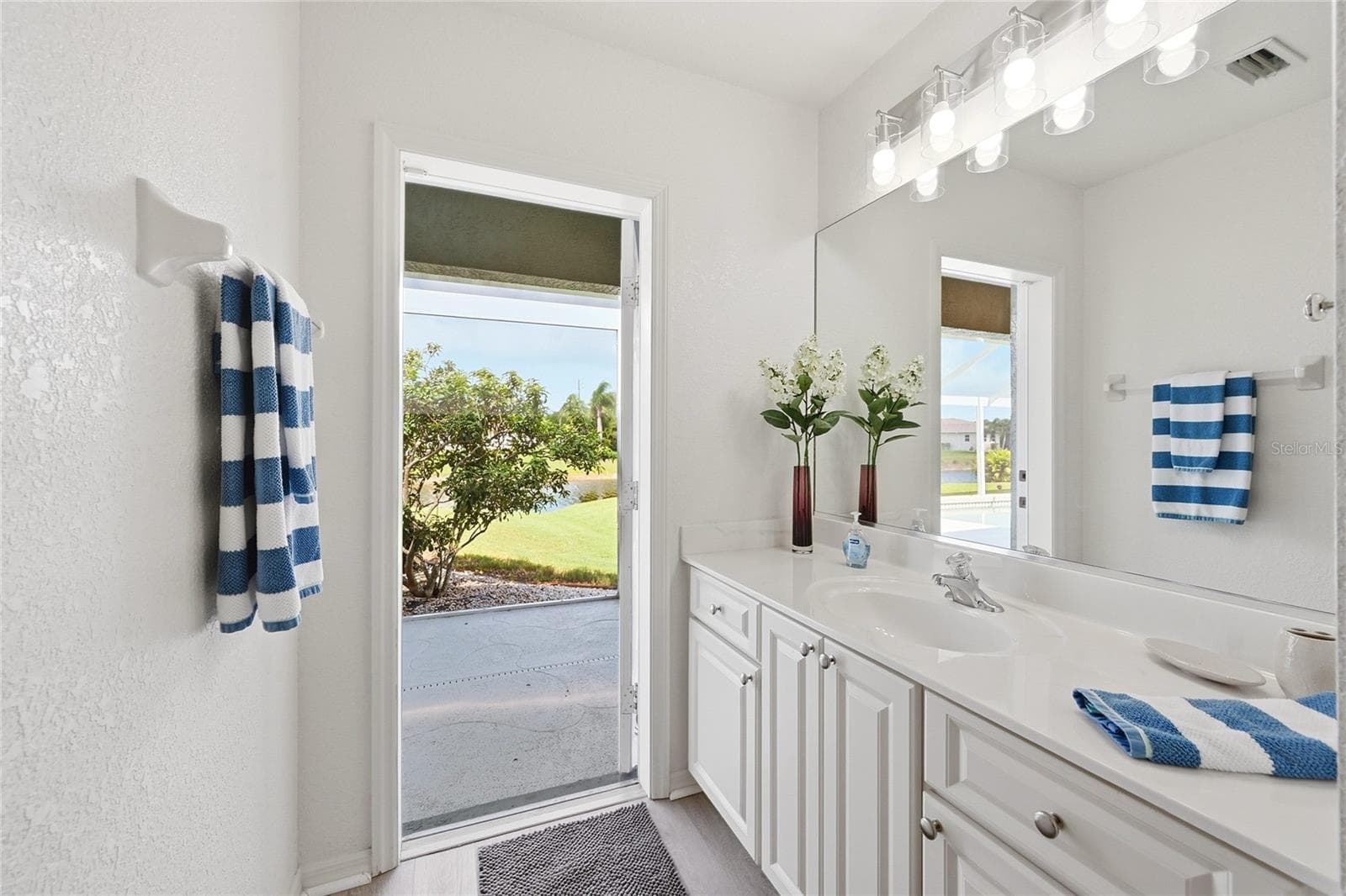 Jack and Jill Bath has a doorway to the Pool Area - 816 BOUNDARY BLVD, ROTONDA WEST